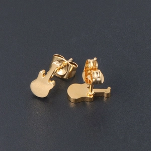 Minimalist 24K gold plated titanium steel guitar stud earrings on dark background