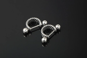 Detail view of twisted rope texture on silver steel punk ear studs with screw ball ends