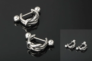 Macro shot of silver stainless steel twisted knot stud earrings with screw-back ball closures