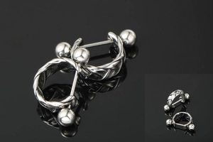 Macro view of silver braided twist earrings with a threaded ball back closure