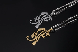 Detailed close-up of dragon totem pendants in polished gold and silver finishes