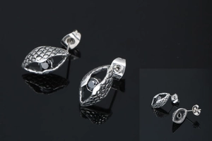Macro detail of men's titanium steel earring featuring snake scale texture and black stone