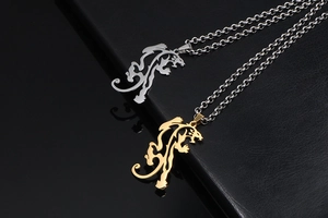 Detailed view of hollow tribal dragon pendants in gold and silver finish with O-chains