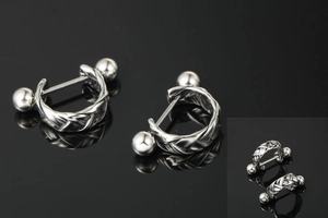 Detail of silver twisted weave earrings with polished ball ends on black background