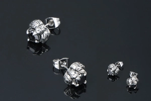 Macro detail of gothic dragon claw stud earrings with black agate stone in vintage finish