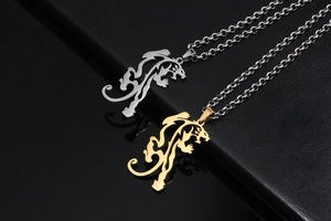 Detailed view of hollow tiger pendant necklaces in polished gold and silver finishes