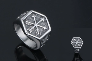 Macro shot of punk style hexagonal signet ring with crossed arrow relief and stars