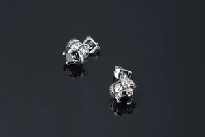 Detail of gothic raven head earrings with black stones and vintage silver finish