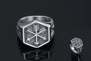Macro detail of punk stainless steel ring with hexagonal face and arrow engraving
