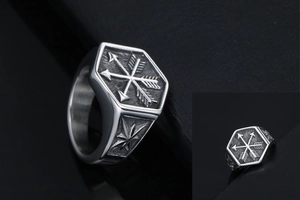 Macro shot of punk style stainless steel ring with hexagonal arrow and star engravings