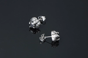 Macro shot of punk dragon claw earrings featuring black stones and oxidized silver finish