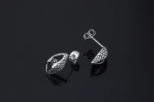 Detail view of retro men's steel ear studs with dragon scales and black stones