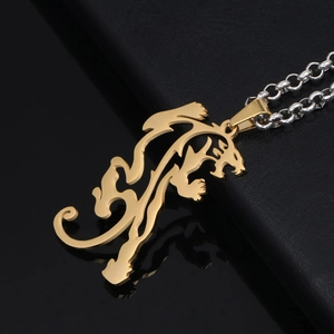 Golden dragon beast pendant necklace on black leather background with metallic chain link
