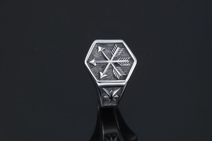 Detail of vintage hexagonal steel ring featuring three crossed arrows in punk style