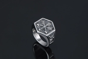 Macro detail of punk signet ring with crossed arrows and sunburst engraving