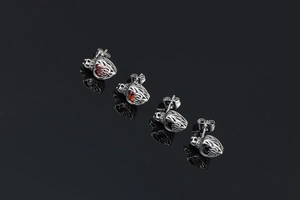 Detailed view of silver heart crown earrings with red and black crystal stones