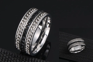 Detail of punk titanium steel wide ring with black zircons and cuban chain texture
