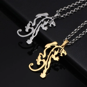 Minimalist gold and silver leopard pendant necklaces on black leather display base