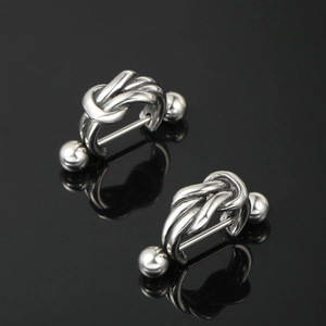 Polished titanium steel knot stud earrings with screw ball backing on black background
