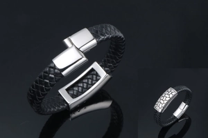Detail of black woven leather bracelet with polished silver metal buckle and clasp