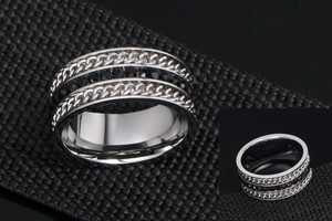 Macro shot of silver titanium steel ring featuring braided chain texture and black stones