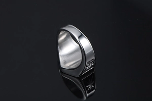 Macro shot of punk style stainless steel ring featuring star and leaf relief patterns