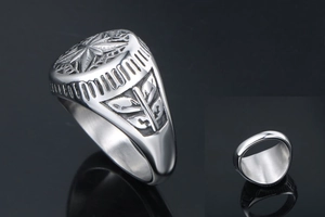 Close-up of titanium steel signet ring with compass star design and leaf relief details