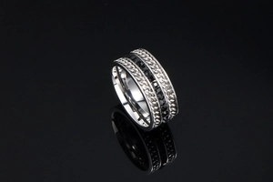 Detail of silver titanium steel ring with black zircon stones and cuban chain texture
