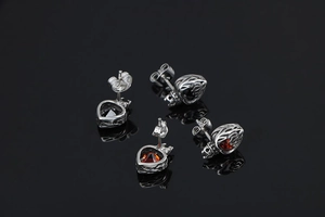 Detail of titanium steel crown heart stud earrings with red and black stones