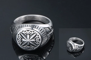 Macro view of vintage stainless steel signet ring with detailed compass relief design