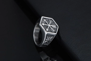 Macro view of a hexagonal punk ring with double arrow engravings on black leather