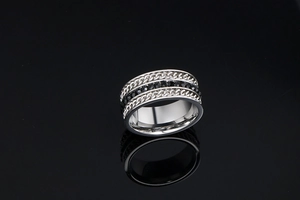 Macro shot of titanium steel ring with twisted rope edges and black zircon inlays