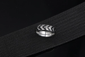 Macro detail of men's titanium steel ring with black tire tread pattern on black band
