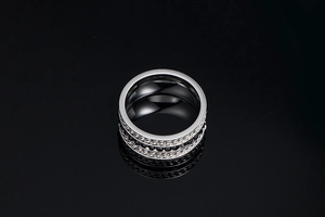 Macro shot of titanium steel ring with black crystals and chain texture band