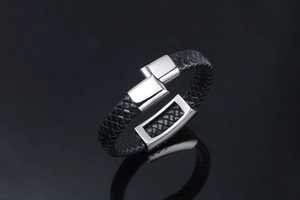 Close-up of black braided leather bracelet with polished silver stainless steel clasp