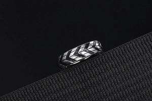 Detailed view of titanium steel tire tread ring with black industrial arrow patterns