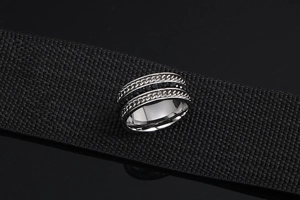 Macro shot of silver titanium steel ring with chain texture and black cubic zirconia stones