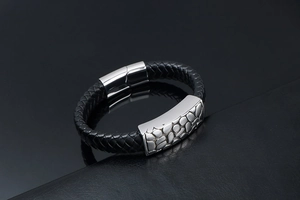 Macro view of woven leather texture and textured silver metal clasp on mens bracelet