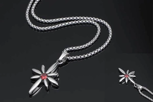 Macro shot of punk star pendant with red gemstone on a polished steel chain