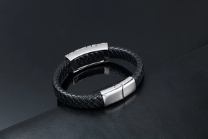 Detail of black woven leather bracelet with brushed silver magnetic metal clasp