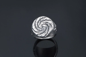 Macro detail of men's titanium steel ring with unique punk vortex texture and oxidized finish