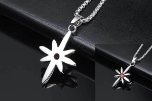 Macro detail of starburst pendant with red gemstone and silver punk style chain