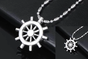 Macro shot of silver stainless steel nautical ship wheel pendant on a ball chain