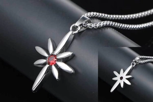 Detailed macro view of a punk style star necklace with a central red gemstone and silver chain