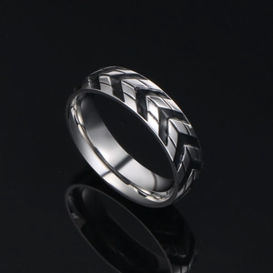 Titanium steel men's ring featuring industrial tire tread pattern on black background