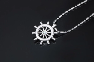 Macro view of silver helm pendant with sparkling crystal inlay on a bead chain