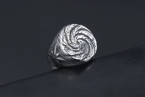 Macro detail of silver punk titanium steel ring with spiral relief and cross star pattern