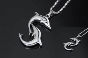 Polished silver dolphin pendant necklace with dual animal design on black mirror surface