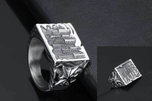 Close-up of vintage titanium steel signet ring with abacus pattern and star relief