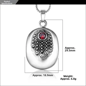 Detail view of Hamsa pendant dimensions 29.5mm x 18.9mm with red ruby stone